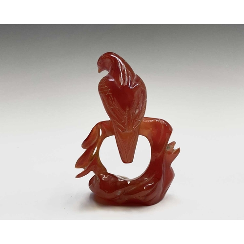 302 - A carved quartz sculpture of a dog, height 5.5cm, together with an agate figure of an eagle, and two... 