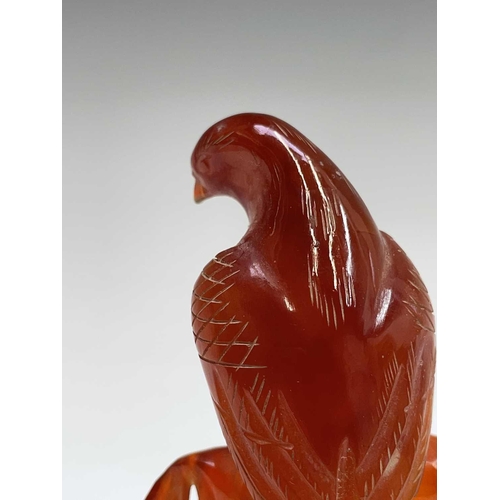 302 - A carved quartz sculpture of a dog, height 5.5cm, together with an agate figure of an eagle, and two... 