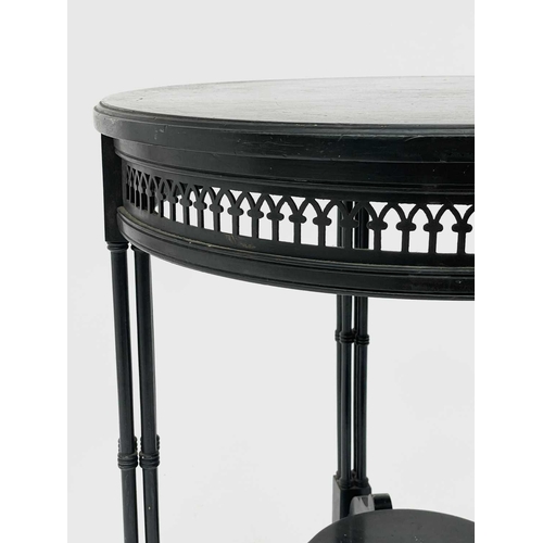 3023 - A late Victorian ebonised circular occasional table, with Gothic pierced frieze and raised on quadru... 