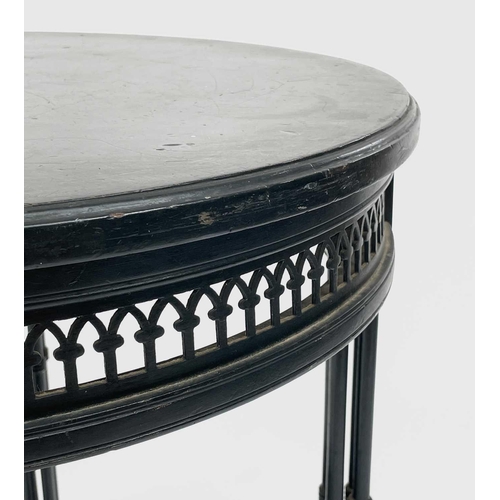 3023 - A late Victorian ebonised circular occasional table, with Gothic pierced frieze and raised on quadru... 