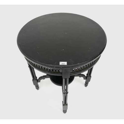 3023 - A late Victorian ebonised circular occasional table, with Gothic pierced frieze and raised on quadru... 