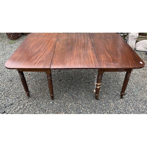 3028 - A Regency mahogany extending dining table, with two D ends and an additional leaf, raised on spiral ... 