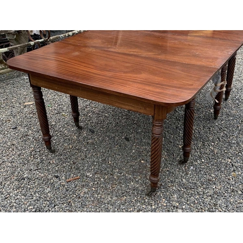 3028 - A Regency mahogany extending dining table, with two D ends and an additional leaf, raised on spiral ... 