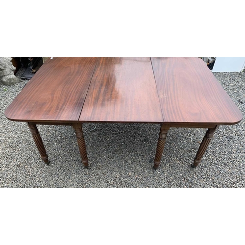 3028 - A Regency mahogany extending dining table, with two D ends and an additional leaf, raised on spiral ... 