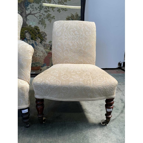 3031 - An Edwardian upholstered armchair on turned front legs, together with a Victorian mahogany nursing c... 