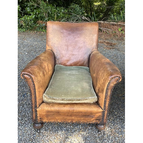 3040 - A pair of leather-upholstered club-type armchairs with studded decoration and raised on turned front... 