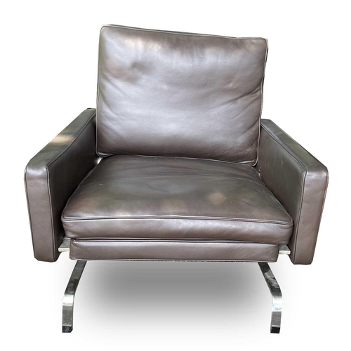 3047 - A contemporary stainless steel and leather upholstered armchair, height 77cm, width 81cm, depth 79cm... 