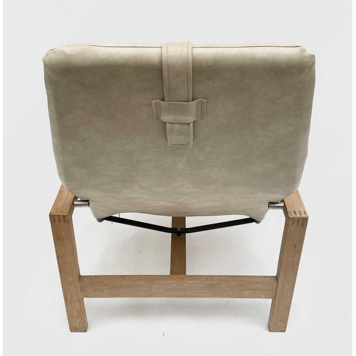 3051 - A beech framed armchair, late 1960s, with later padded upholstery and raised on plain rectangular su... 