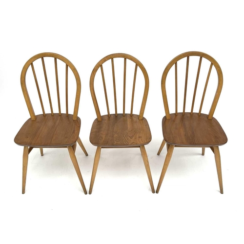 3056 - A set of three Ercol beech and light elm hoop back dining chairs, stamped to the underside with kite... 