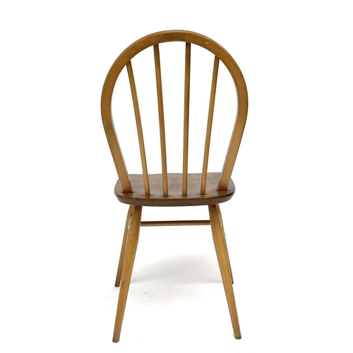 3056 - A set of three Ercol beech and light elm hoop back dining chairs, stamped to the underside with kite... 