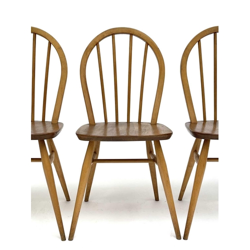 3056 - A set of three Ercol beech and light elm hoop back dining chairs, stamped to the underside with kite... 