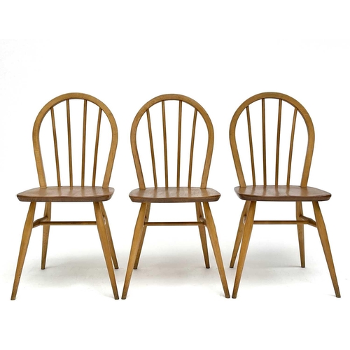 3056 - A set of three Ercol beech and light elm hoop back dining chairs, stamped to the underside with kite... 