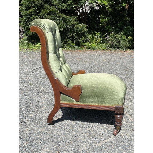 3057 - A late Victorian mahogany low salon chair, with green buttoned dralon upholstery and swept moulded f... 