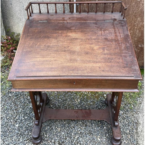 3059 - A Regency mahogany clerk's desk, with spindle gallery and sloping top, flanked by two drawers with b... 