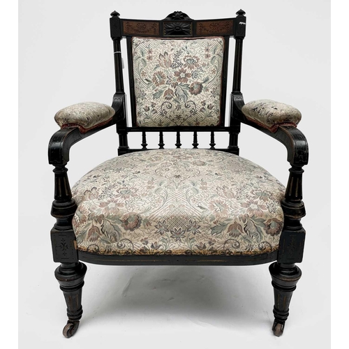 3060 - A Victorian ebonised aesthetic period armchair, the back with amboyna panels, with turned, gilt and ... 