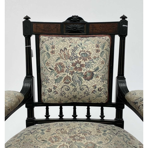 3060 - A Victorian ebonised aesthetic period armchair, the back with amboyna panels, with turned, gilt and ... 