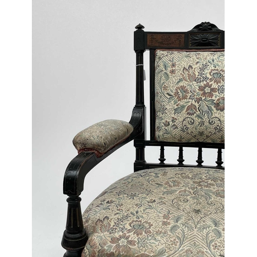 3060 - A Victorian ebonised aesthetic period armchair, the back with amboyna panels, with turned, gilt and ... 