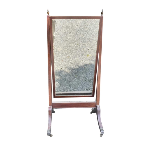 3073 - A Regency mahogany and boxwood strung cheval mirror, with brass urn finials and raised on brass capp... 