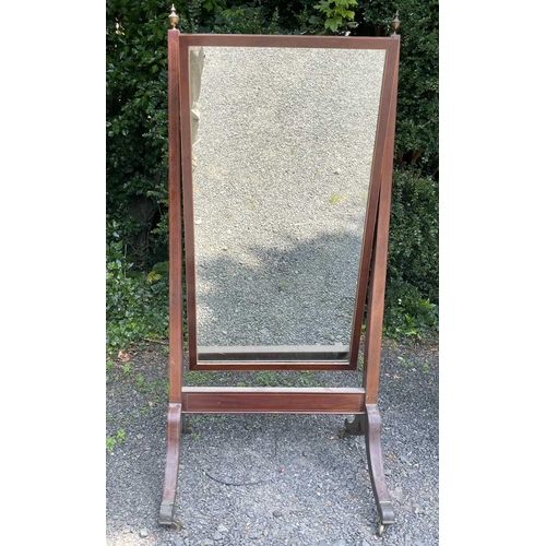 3073 - A Regency mahogany and boxwood strung cheval mirror, with brass urn finials and raised on brass capp... 