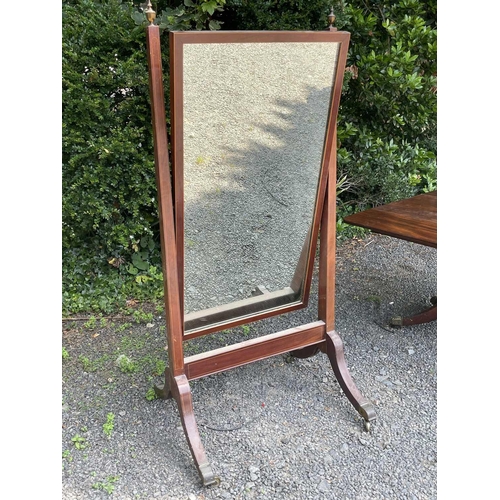 3073 - A Regency mahogany and boxwood strung cheval mirror, with brass urn finials and raised on brass capp... 