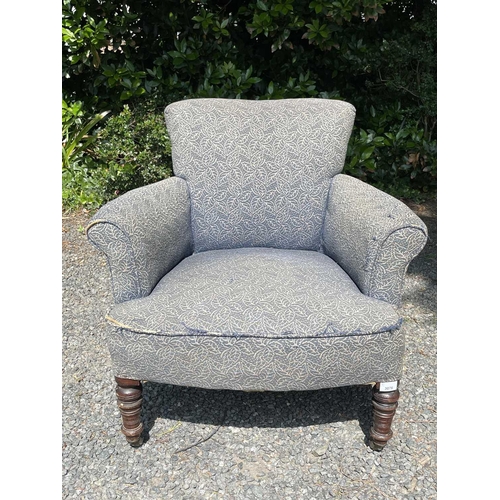 3076 - A late Victorian low armchair, raised on turned front legs and castors, height 72cm, width 73cm, dep... 