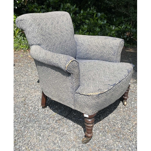 3076 - A late Victorian low armchair, raised on turned front legs and castors, height 72cm, width 73cm, dep... 