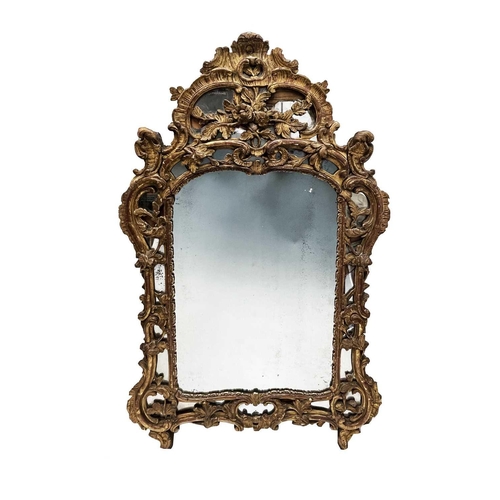 3086 - A George III giltwood mirror, the frame with Rococo scrolls and foliates, and wide mirrored border. ... 