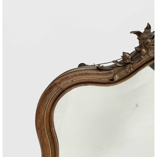 3087 - A late 19th century French walnut and parcel gilt wall mirror, with floral carved cresting and base,... 