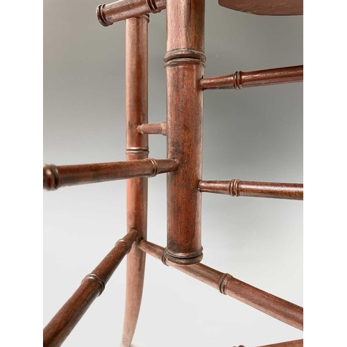 3088 - An Arts and Crafts mahogany stand, with three staggered leaf shape tiers and simulated bamboo turned... 