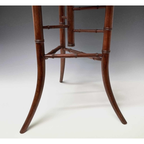 3088 - An Arts and Crafts mahogany stand, with three staggered leaf shape tiers and simulated bamboo turned... 