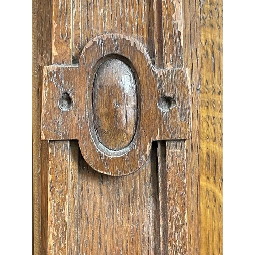 3096 - A Continental oak side cabinet, late 19th century, the two doors carved with cherub masks, fruit lad... 