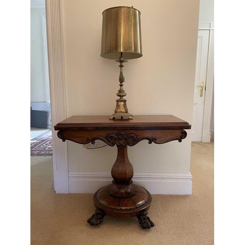 3105 - A William IV rosewood fold top tea table, raised on an octagonal baluster pillar and carved circular... 