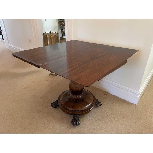 3105 - A William IV rosewood fold top tea table, raised on an octagonal baluster pillar and carved circular... 