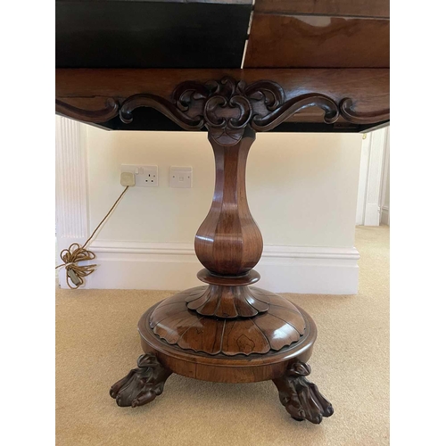 3105 - A William IV rosewood fold top tea table, raised on an octagonal baluster pillar and carved circular... 