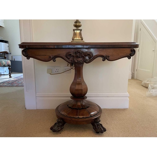 3105 - A William IV rosewood fold top tea table, raised on an octagonal baluster pillar and carved circular... 