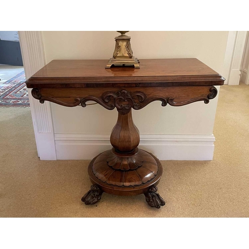 3105 - A William IV rosewood fold top tea table, raised on an octagonal baluster pillar and carved circular... 