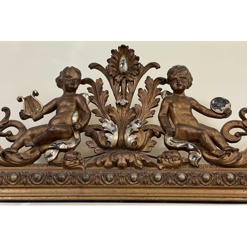 3107 - A French ornate gilt-gesso wall mirror, late 19th century, surmounted by two cherubs playing musical... 