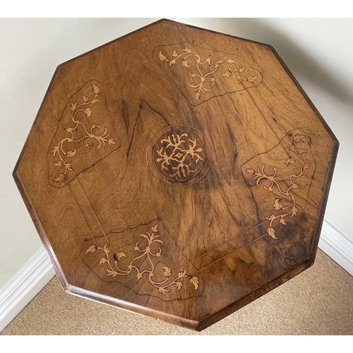 3108 - A Victorian walnut and inlaid octagonal work table, with fitted interior and raised on a carved trip... 