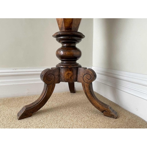 3108 - A Victorian walnut and inlaid octagonal work table, with fitted interior and raised on a carved trip... 