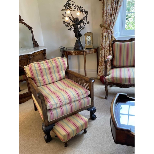 3113 - A pair of beech and walnut framed Bergere armchairs, circa 1920, with caned backs and arms, on carve... 