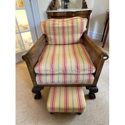 3113 - A pair of beech and walnut framed Bergere armchairs, circa 1920, with caned backs and arms, on carve... 