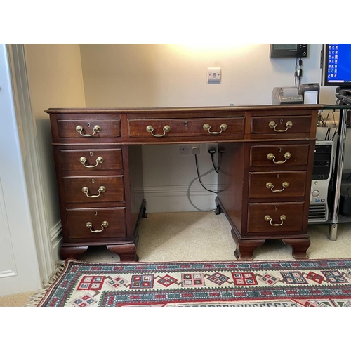 3117 - An Edwardian mahogany twin pedestal writing desk, with tooled leather skiver, and fitted with an arr... 