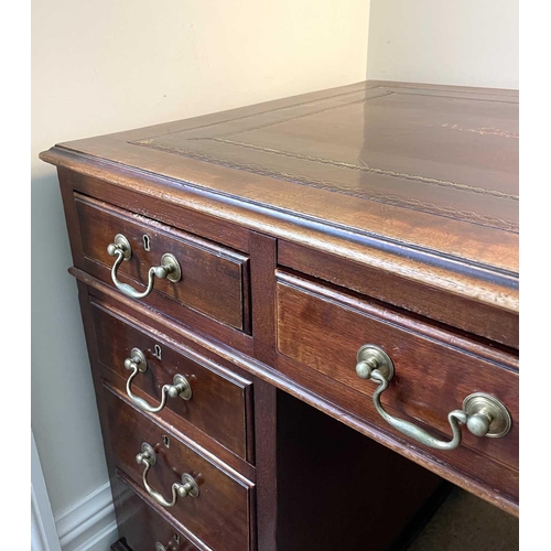 3117 - An Edwardian mahogany twin pedestal writing desk, with tooled leather skiver, and fitted with an arr... 