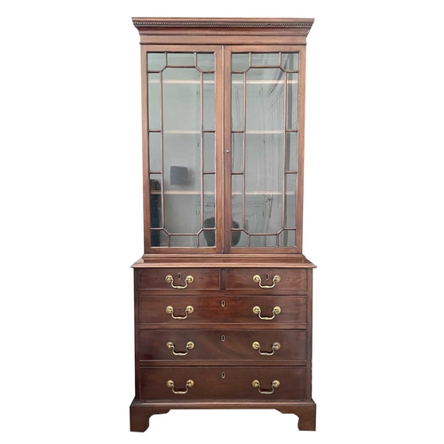 3119 - A mahogany bookcase cabinet, the upper part with glazed door enclosing three adjustable shelves, the... 