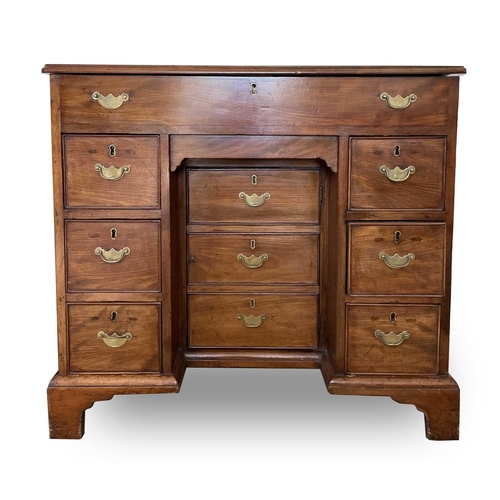 3123 - A George III mahogany kneehole gentleman's dressing chest, the rising top containing compartments an... 