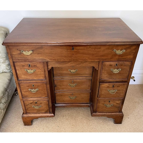 3123 - A George III mahogany kneehole gentleman's dressing chest, the rising top containing compartments an... 