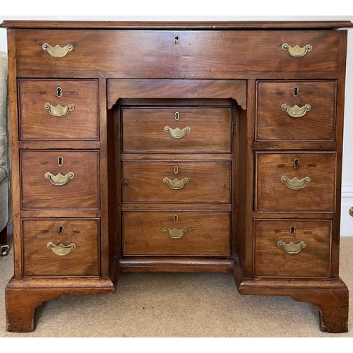 3123 - A George III mahogany kneehole gentleman's dressing chest, the rising top containing compartments an... 