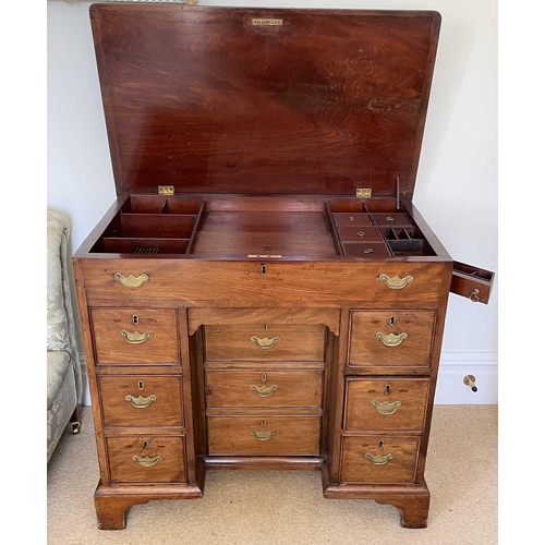 3123 - A George III mahogany kneehole gentleman's dressing chest, the rising top containing compartments an... 