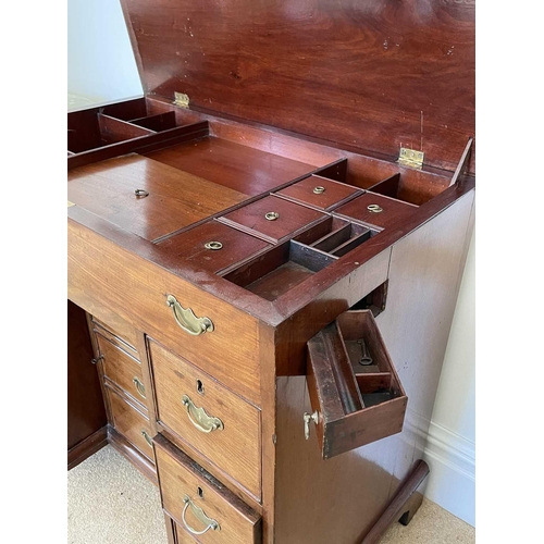 3123 - A George III mahogany kneehole gentleman's dressing chest, the rising top containing compartments an... 