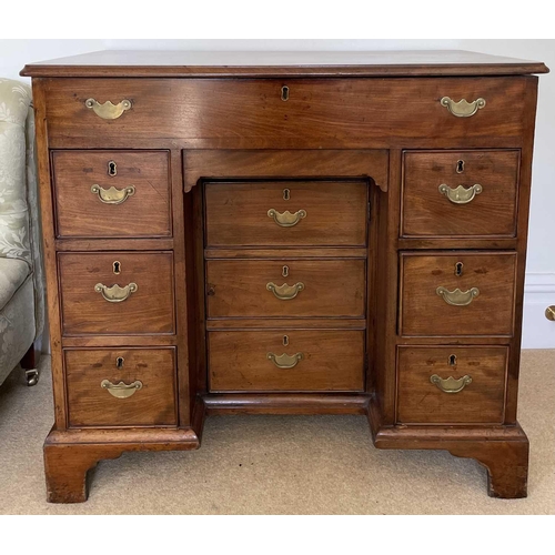 3123 - A George III mahogany kneehole gentleman's dressing chest, the rising top containing compartments an... 